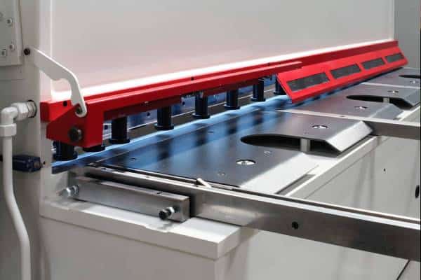 Industrial sheet metal bending machine in operation.