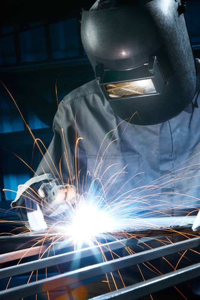 Welder working with bright sparks flying.