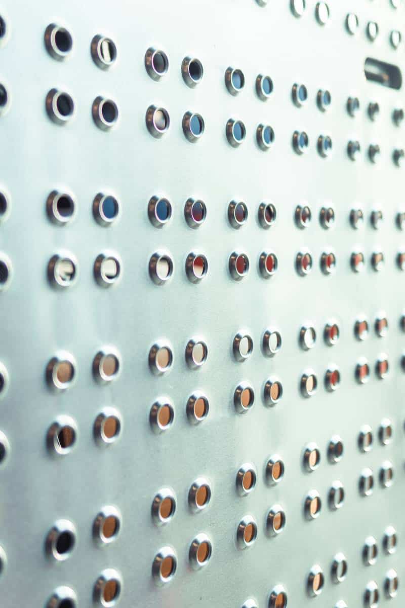 Metal panel with circular perforations in pattern.